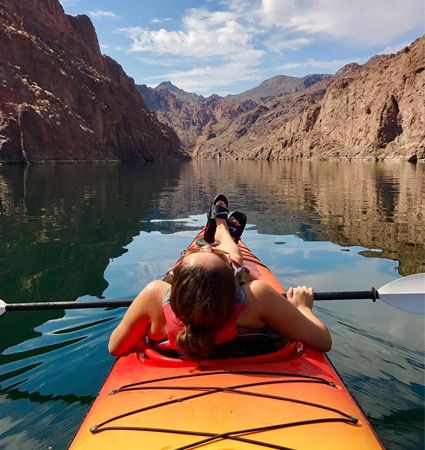 Kayaker on the green water of the Colorado River in Black Canyon